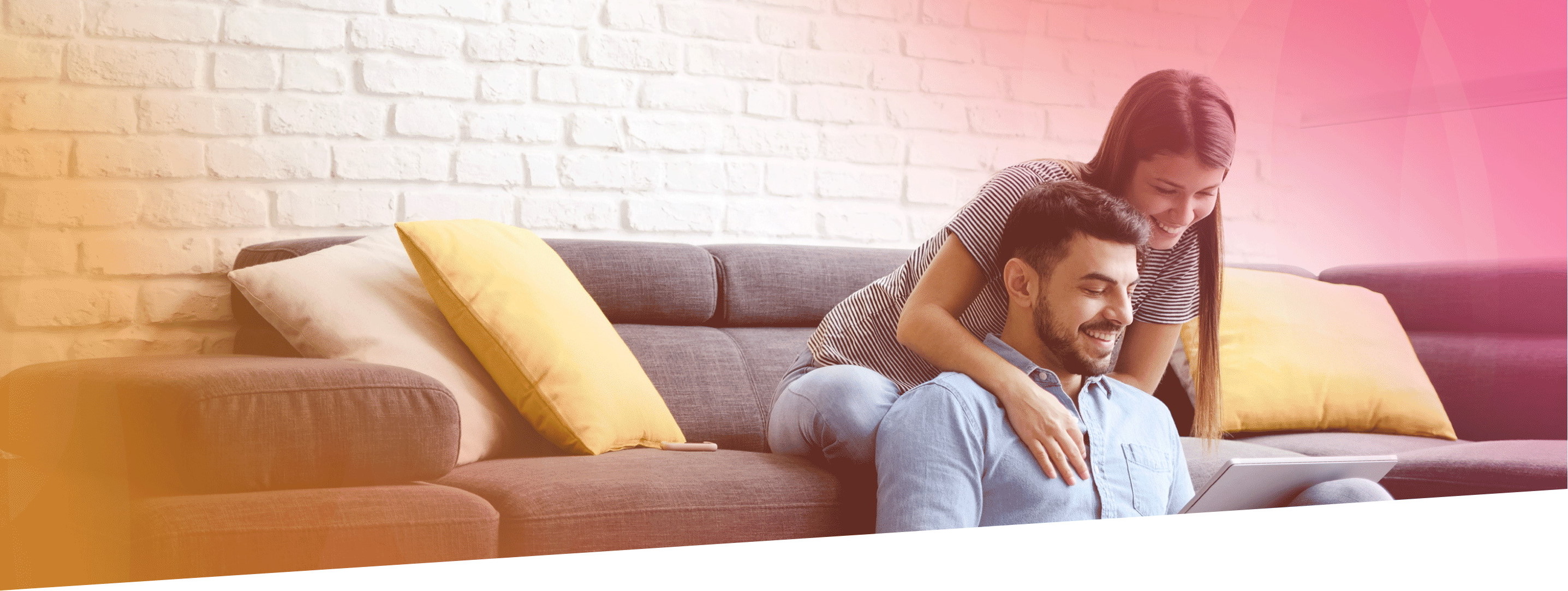 A young couple smiles as they view their online Gas South account from their tablet